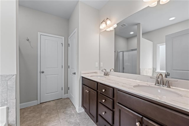 350 Paces Dr, Lithia Springs, GA 30122 - bathroom with double vanity, a stall shower, a bathtub, and baseboards