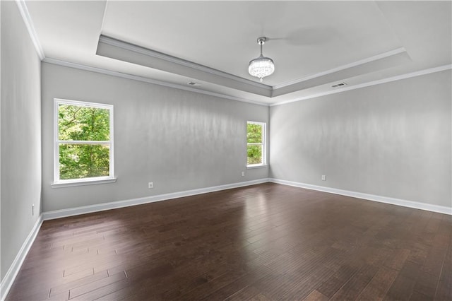 350 Paces Dr, Lithia Springs, GA 30122 - empty room featuring a raised ceiling, crown molding, dark wood finished floors, and baseboards