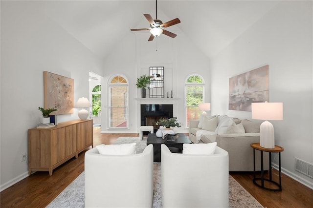4085 Tritt Homestead Dr, Marietta, GA 30062 - living room featuring high vaulted ceiling, ceiling fan, a fireplace, dark wood-type flooring, and baseboards