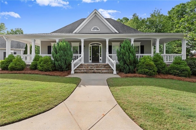 4085 Tritt Homestead Dr, Marietta, GA 30062 - farmhouse with a front lawn, covered porch, and roof with shingles