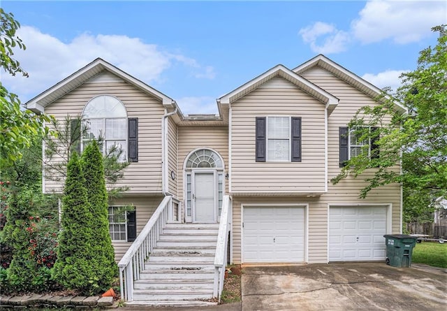 split foyer home featuring a garage and driveway