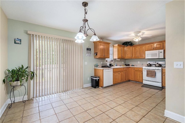 kitchen with light tile patterned flooring, white appliances, baseboards, ceiling fan, and light countertops