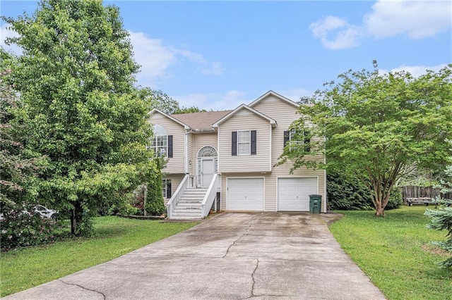 bi-level home featuring an attached garage, a front lawn, and driveway