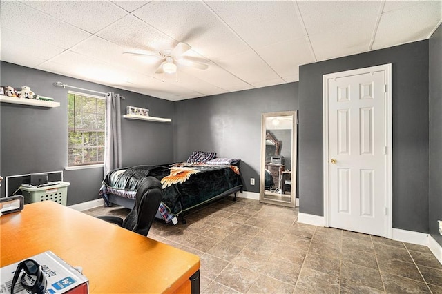 bedroom with baseboards and ceiling fan