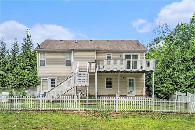 back of house with stairs, a fenced backyard, a wooden deck, and a yard