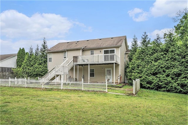 back of property featuring stairs, a fenced backyard, a lawn, and a deck