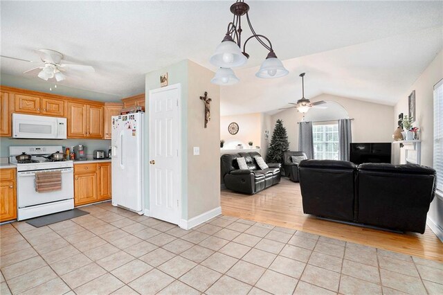 kitchen featuring a ceiling fan, light tile patterned floors, white appliances, and light countertops