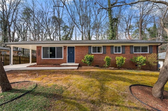 ranch-style home featuring a carport and a front lawn