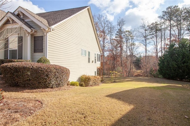 view of side of property with a lawn