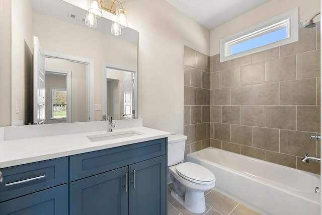 full bathroom with tiled shower / bath, a healthy amount of sunlight, vanity, and tile patterned floors