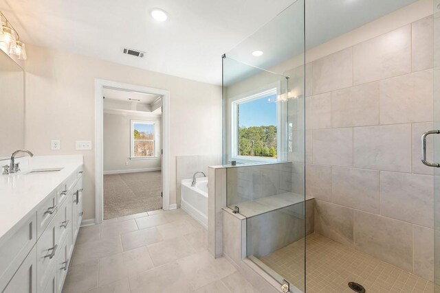 bathroom featuring tile patterned floors, independent shower and bath, and vanity