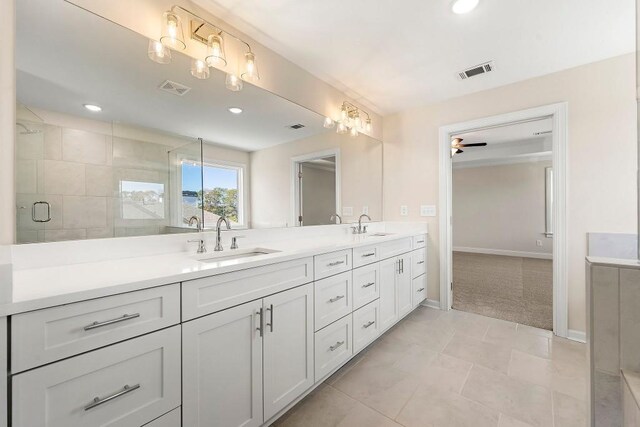 bathroom with dual vanity, ceiling fan, and tile patterned floors