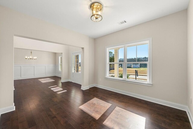 interior space with wood-type flooring and a chandelier