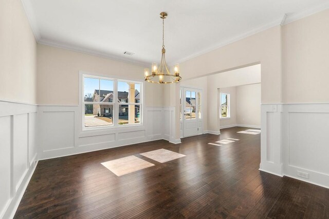 interior space featuring crown molding, dark wood-type flooring, and an inviting chandelier