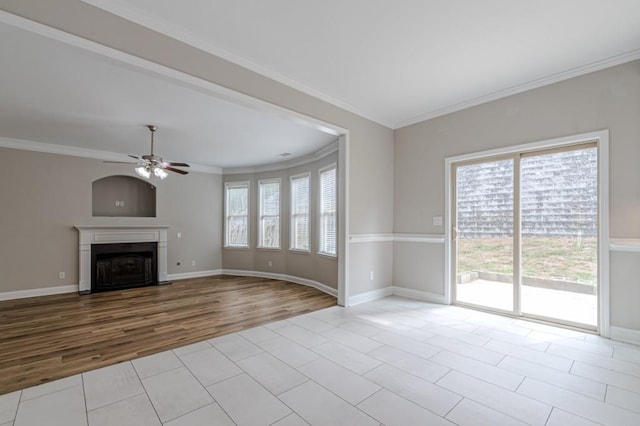 unfurnished living room with crown molding, ceiling fan, and light hardwood / wood-style flooring