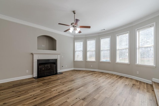 unfurnished living room featuring light hardwood / wood-style floors, ceiling fan, and crown molding