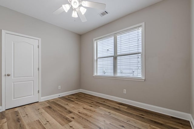 empty room with light hardwood / wood-style floors and ceiling fan