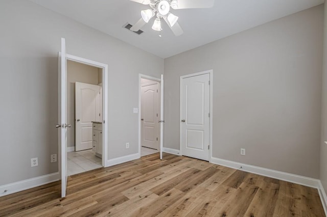 unfurnished bedroom featuring light wood-type flooring and ceiling fan