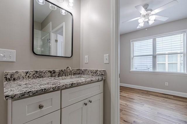 bathroom with vanity, hardwood / wood-style flooring, and ceiling fan