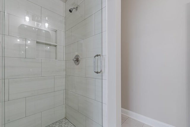 bathroom featuring tile patterned flooring and an enclosed shower