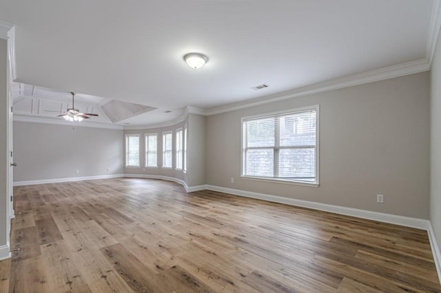 empty room featuring ornamental molding, light hardwood / wood-style floors, and ceiling fan