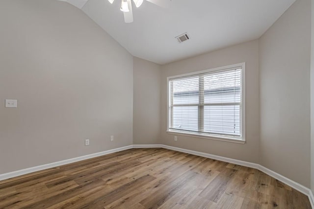 spare room with ceiling fan, hardwood / wood-style flooring, and vaulted ceiling