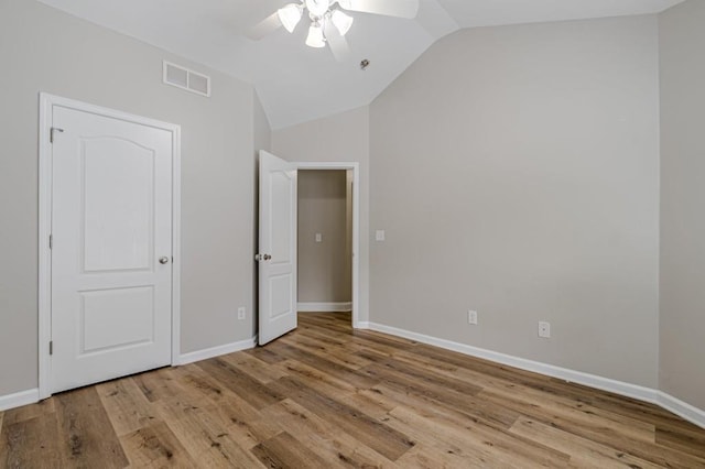 unfurnished bedroom featuring light wood-type flooring, vaulted ceiling, and ceiling fan