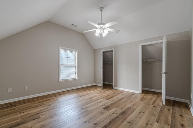 unfurnished bedroom with ceiling fan, vaulted ceiling, and light hardwood / wood-style floors