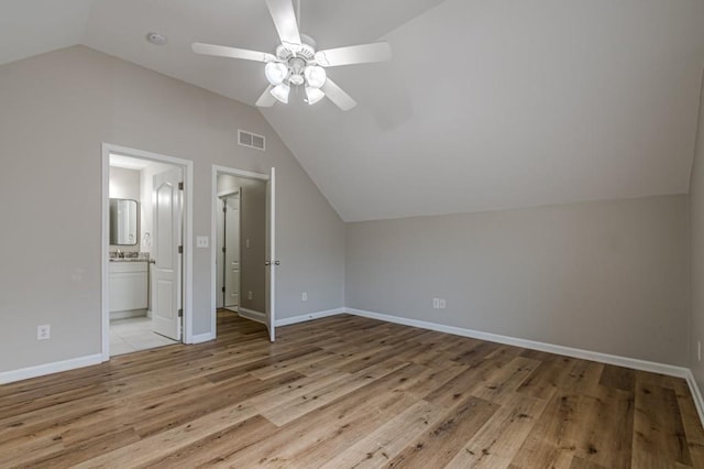 additional living space with ceiling fan, light wood-type flooring, and vaulted ceiling