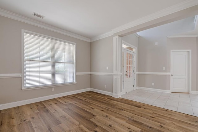 spare room with light wood-type flooring and crown molding