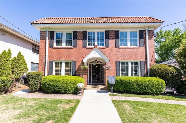 view of front facade featuring a front lawn and brick siding
