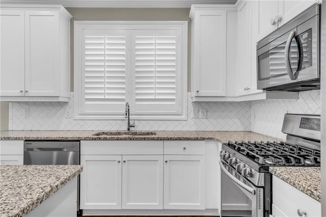 1547 Cambridge Pl, Marietta, GA 30062 - kitchen with appliances with stainless steel finishes, a sink, white cabinets, backsplash, and light stone countertops