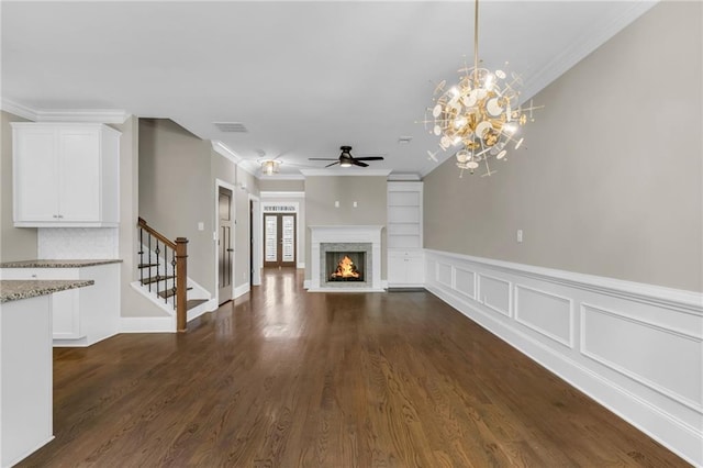 1547 Cambridge Pl, Marietta, GA 30062 - unfurnished living room featuring ceiling fan, stairway, a warm lit fireplace, dark wood-type flooring, and crown molding