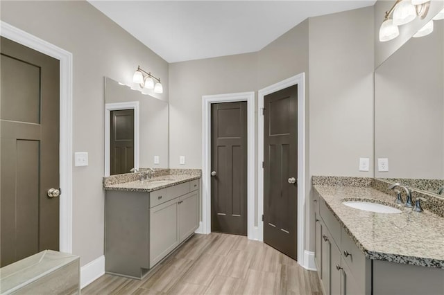 1547 Cambridge Pl, Marietta, GA 30062 - full bath featuring two vanities, baseboards, and wood finished floors