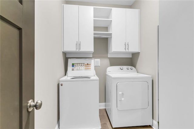 1547 Cambridge Pl, Marietta, GA 30062 - laundry room featuring cabinet space, washer and clothes dryer, baseboards, and tile patterned floors