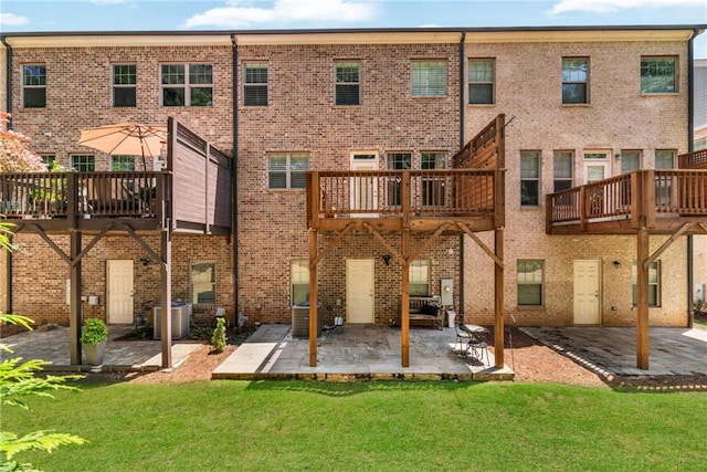 1547 Cambridge Pl, Marietta, GA 30062 - back of house featuring a yard, a patio, cooling unit, and brick siding