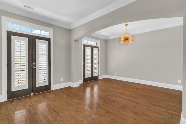 1547 Cambridge Pl, Marietta, GA 30062 - foyer entrance featuring french doors, arched walkways, dark wood-type flooring, ornamental molding, and a chandelier
