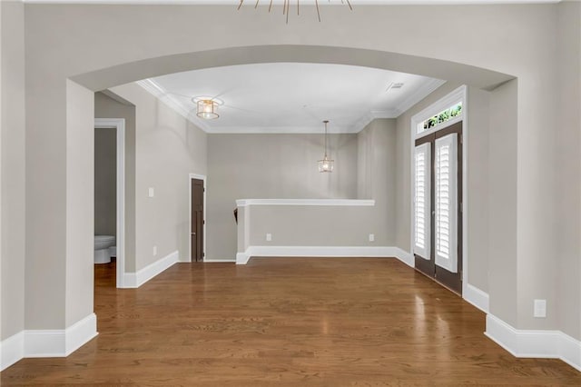 1547 Cambridge Pl, Marietta, GA 30062 - unfurnished room with ornamental molding, wood finished floors, arched walkways, and baseboards
