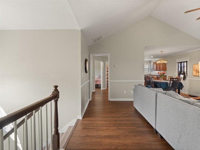 hallway with dark hardwood / wood-style flooring and vaulted ceiling