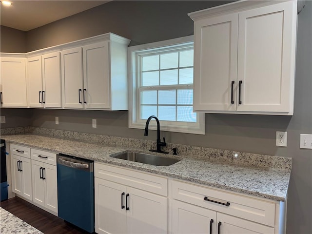 kitchen with white cabinetry, sink, stainless steel dishwasher, and light stone counters