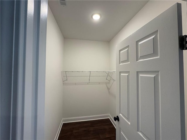 washroom featuring dark hardwood / wood-style flooring, electric water heater, and hookup for a washing machine