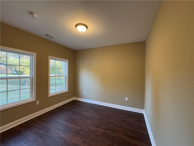 empty room featuring dark hardwood / wood-style flooring