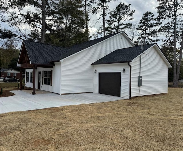 view of home's exterior with a yard, a garage, and a patio area