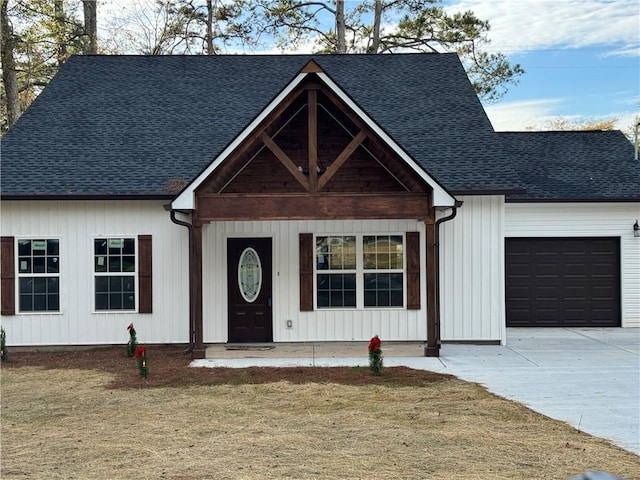 view of front of home with a garage and a front yard