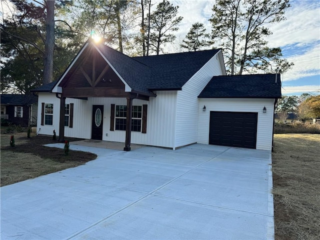 modern inspired farmhouse with covered porch and a garage