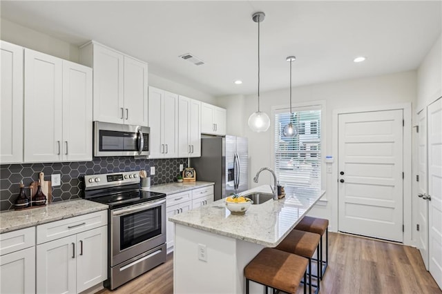 1095 Tucker Ave Unit 203, Atlanta, GA 30310 - kitchen with appliances with stainless steel finishes, wood finished floors, backsplash, and recessed lighting