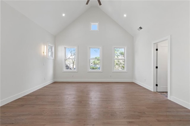 1857 Defoor Ave, Atlanta, GA 30318 - unfurnished living room with wood finished floors, a wealth of natural light, and high vaulted ceiling