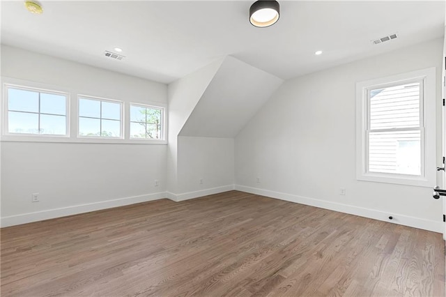 1857 Defoor Ave, Atlanta, GA 30318 - additional living space with baseboards, visible vents, vaulted ceiling, and light wood-style floors
