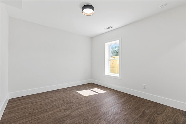 1857 Defoor Ave, Atlanta, GA 30318 - unfurnished room featuring baseboards, dark wood-style flooring, and visible vents