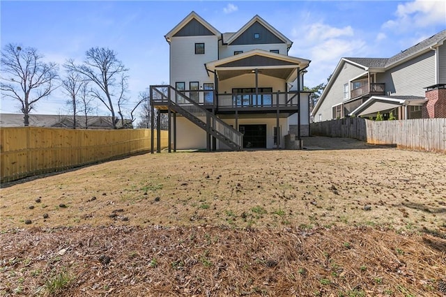 1857 Defoor Ave, Atlanta, GA 30318 - back of house with a fenced backyard, a wooden deck, board and batten siding, and stairway